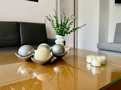 a table with a vase and bowls on top of it at GRAND medellin in Medellín