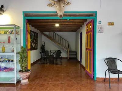 a room with a door and a table and chairs at Finca Hotel Mariangel in El Peñol