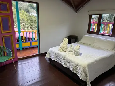a bedroom with a bed with angel wings on it at Finca Hotel Mariangel in El Peñol