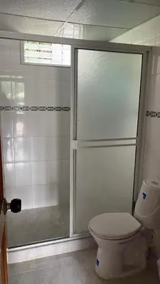 a bathroom with a shower and a toilet at Finca Hotel Mariangel in El Peñol