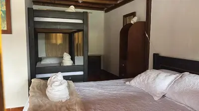 a bedroom with a bunk bed and a mirror at Finca Hotel Mariangel in El Peñol