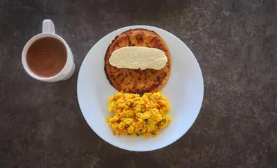 a plate of food with eggs and a cup of coffee at Pure San Carlos Nature Reserve Bio Cabin
