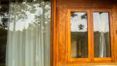 a window with a wooden frame and a curtain at Pure San Carlos Nature Reserve Bio Cabin