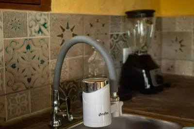 a cup sitting on a sink next to a kitchen sink at Pure San Carlos Nature Reserve Bio Cabin