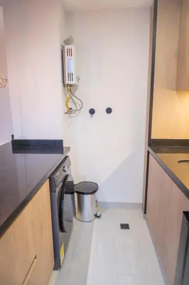 a small kitchen with a trash can in the corner at Estrena Apto Moderno para Viajeros con Estilo in Medellín