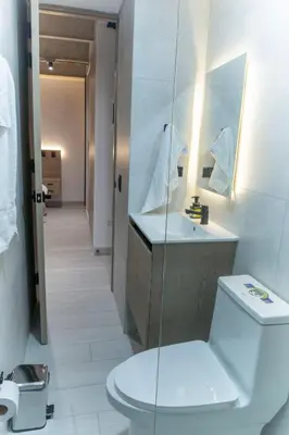 a bathroom with a toilet and a sink at Estrena Apto Moderno para Viajeros con Estilo in Medellín
