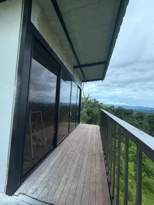 a balcony of a house with large glass windows at Chocochucho Agroecoturismo in Amalfi