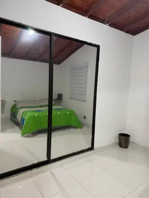a mirror in a room with a bed in it at Apartamento Comuna 13 in Medellín