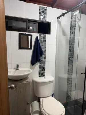 a bathroom with a toilet and a sink and a shower at Apartamento Comuna 13 in Medellín