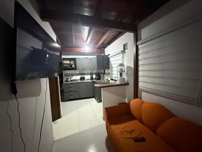 a small kitchen with an orange couch in a room at Apartamento Comuna 13 in Medellín