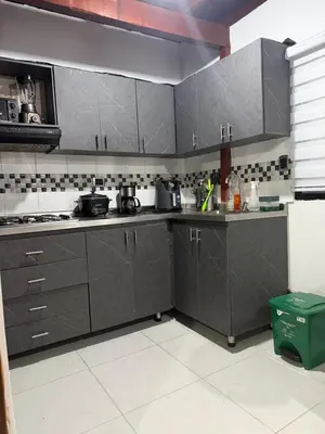 a kitchen with gray cabinets and appliances in it at Apartamento Comuna 13 in Medellín