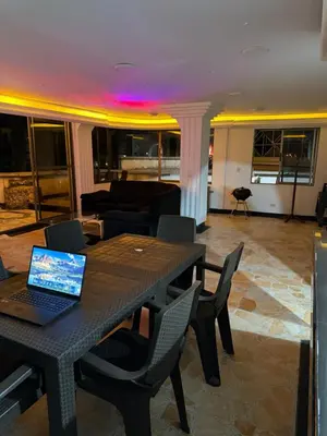 a living room with a table with a laptop on it at Tu alojamiento parque caldas in Manizales