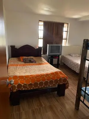 a bedroom with a bed and a tv in it at Casa Finca en el Peñol in Piedra El Marcial