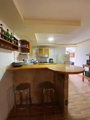 a kitchen with a counter and two stools at a bar at Casa Finca en el Peñol in Piedra El Marcial