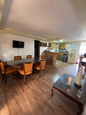 a living room with a table and chairs and a kitchen at Casa Finca en el Peñol in Piedra El Marcial