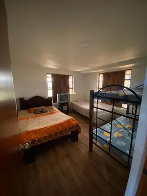 a bedroom with two bunk beds and a desk at Casa Finca en el Peñol in Piedra El Marcial