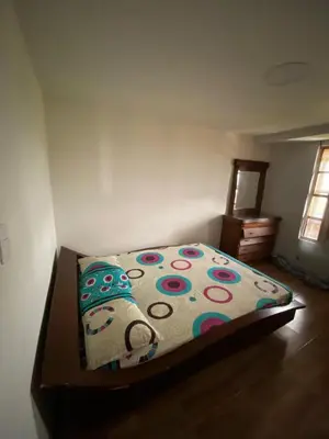 a bedroom with a bed with a colorful comforter at Casa Finca en el Peñol in Piedra El Marcial