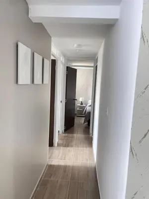a hallway with white walls and wood floors at Apartamento en Manizales Montaña & Café in Estación El Salto