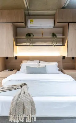 a bedroom with a large bed with white sheets at Stylish Laureles Apartment, New Apartment in Medellín
