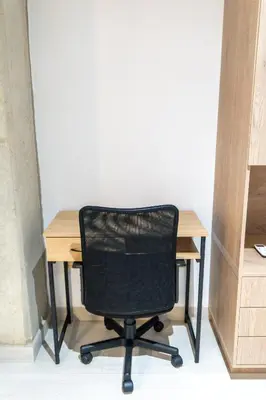 a black chair sitting at a wooden desk at Stylish Laureles Apartment, New Apartment in Medellín