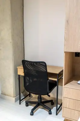 a black chair sitting next to a wooden desk at Stylish Laureles Apartment, New Apartment in Medellín