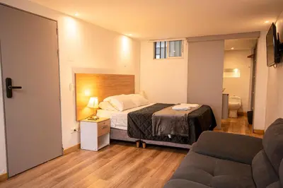 a small bedroom with a bed and a couch at CozyHomesco in Medellín