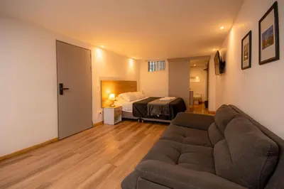 a living room with a couch and a bed at CozyHomesco in Medellín