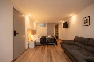 a living room with a bed and a couch at CozyHomesco in Medellín