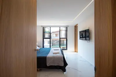 a bedroom with a bed and a large window at CozyHomesco in Medellín