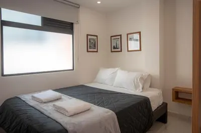 a bedroom with a bed with two towels on it at CozyHomesco in Medellín