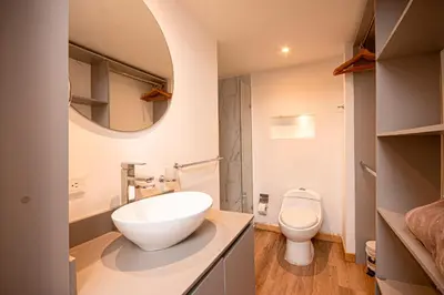 a bathroom with a white sink and a toilet at CozyHomesco in Medellín