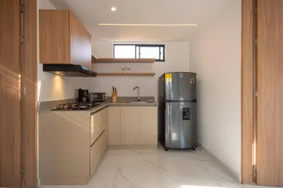 a kitchen with a stainless steel refrigerator and a sink at Cozyhomesco 1 in Medellín