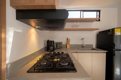 a kitchen with a stove top oven in a kitchen at Cozyhomesco 1 in Medellín