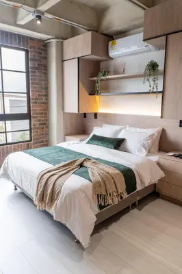 a bedroom with a large bed and a brick wall at New Apartment in Laureles, Modern & Total Comfort in Medellín