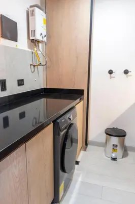 a kitchen with a washing machine and a counter at New Apartment in Laureles, Modern & Total Comfort in Medellín