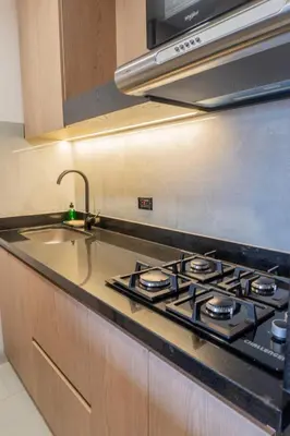 a kitchen with a stove and a sink at New Apartment in Laureles, Modern & Total Comfort in Medellín