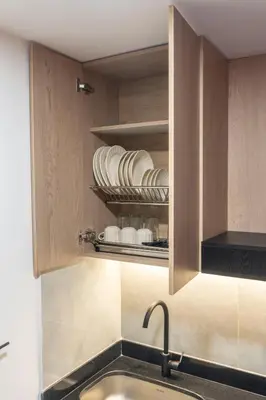 a kitchen with a sink and a shelf with plates at New Apartment in Laureles, Modern & Total Comfort in Medellín