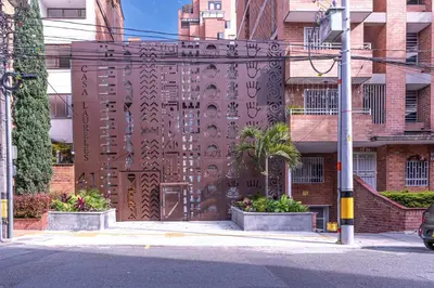 a building with a wooden door with writing on it at Casa Museo Living by HOUSY in Medellín