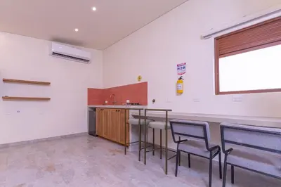 a room with a bar with chairs and a counter at Casa Museo Living by HOUSY in Medellín