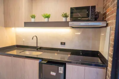 a kitchen with a sink and a microwave at Brand New Premium Apartment with Large Balcony in Medellín