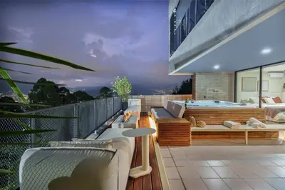 a balcony with a hot tub on a building at Medellin Sky Penthouse in Envigado