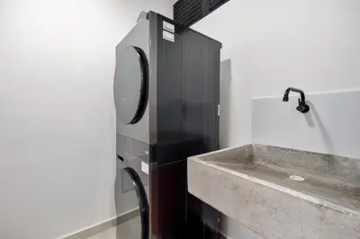 a bathroom with a sink and a faucet at Medellin Sky Penthouse in Envigado