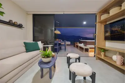 a living room with a couch and a table at Medellin Sky Penthouse in Envigado