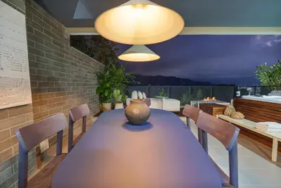 a dining room table with chairs and a vase on it at Medellin Sky Penthouse in Envigado