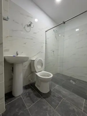 a bathroom with a toilet and a sink and a shower at Finca Villa Sofía in Santa Fe de Antioquia