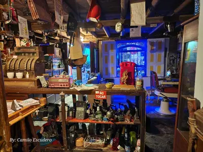 a room with a bunch of bottles on a shelf at Cabañas Miraluna in Santa Elena