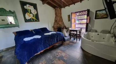 a bedroom with a bed and a bath tub at Cabañas Miraluna in Santa Elena