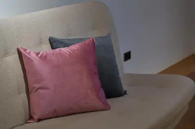 a pink pillow sitting on top of a couch at Casa en Laureles Estadio amplia y cómoda in Medellín
