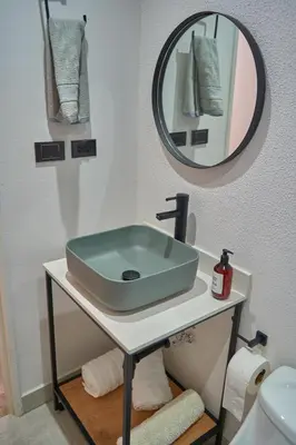 a bathroom with a sink and a mirror at Casa en Laureles Estadio amplia y cómoda in Medellín