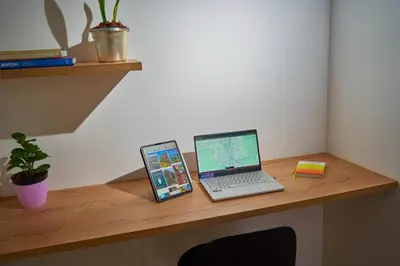 a desk with a laptop and a tablet computer on it at Casa en Laureles Estadio amplia y cómoda in Medellín